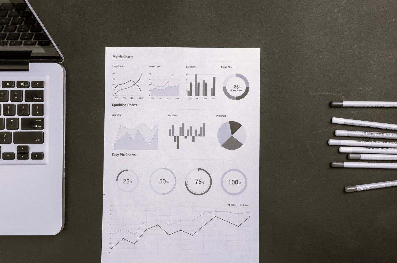 computer with graphs on a paper